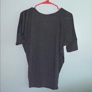 Dark grey shirt. Extra fabric on arms. Looser fit.